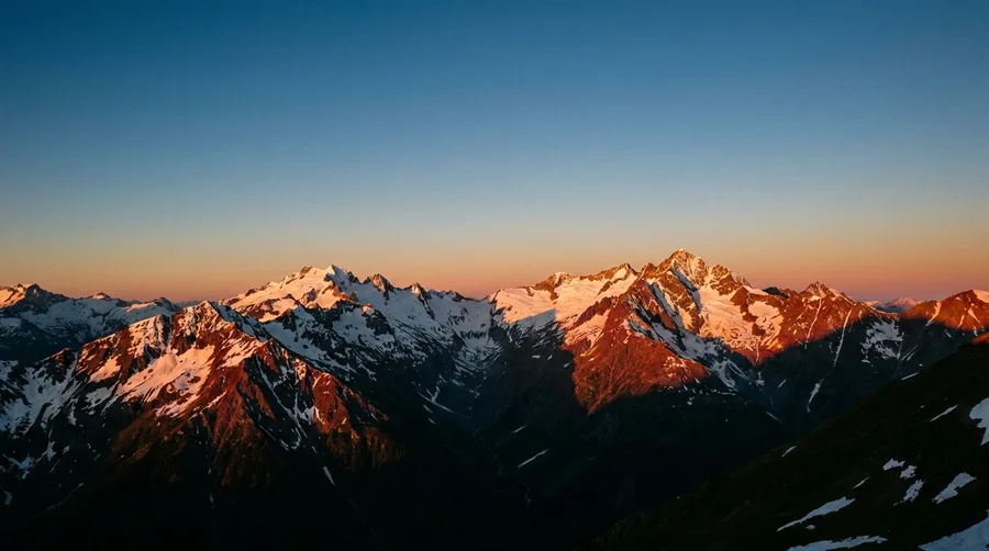 Alpengipfel im Alpenglühen bei Sonnenaufgang als Berge-Bild-Leuchtbild